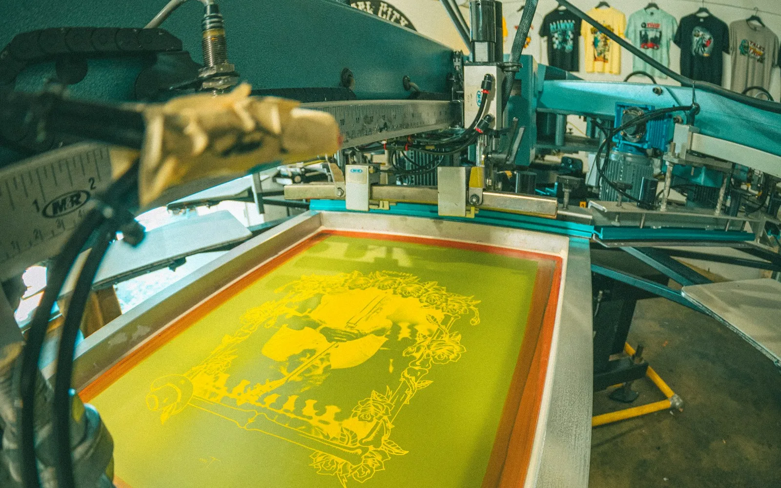 Siebdruckpresse mit Tinte für einen Vergleich zwischen DTF und Siebdruck